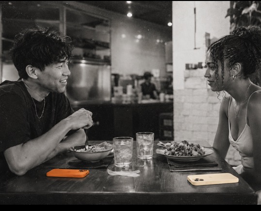 wols app concept: a phone at a restaurant table between two people dining together